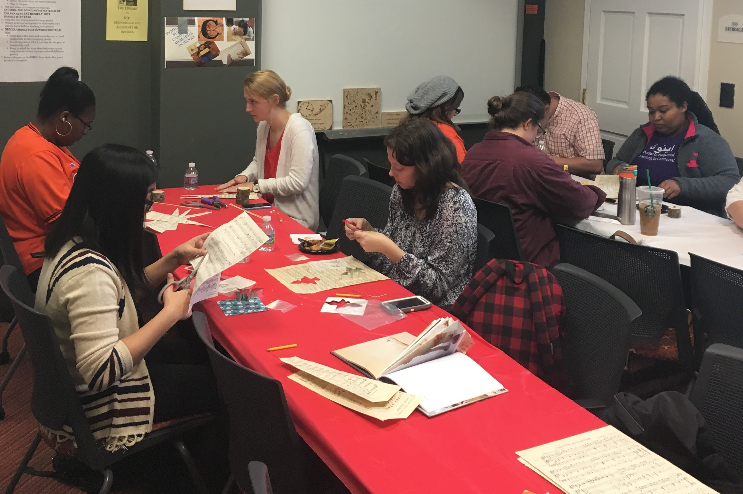 Group of students working on their crafts with books projects