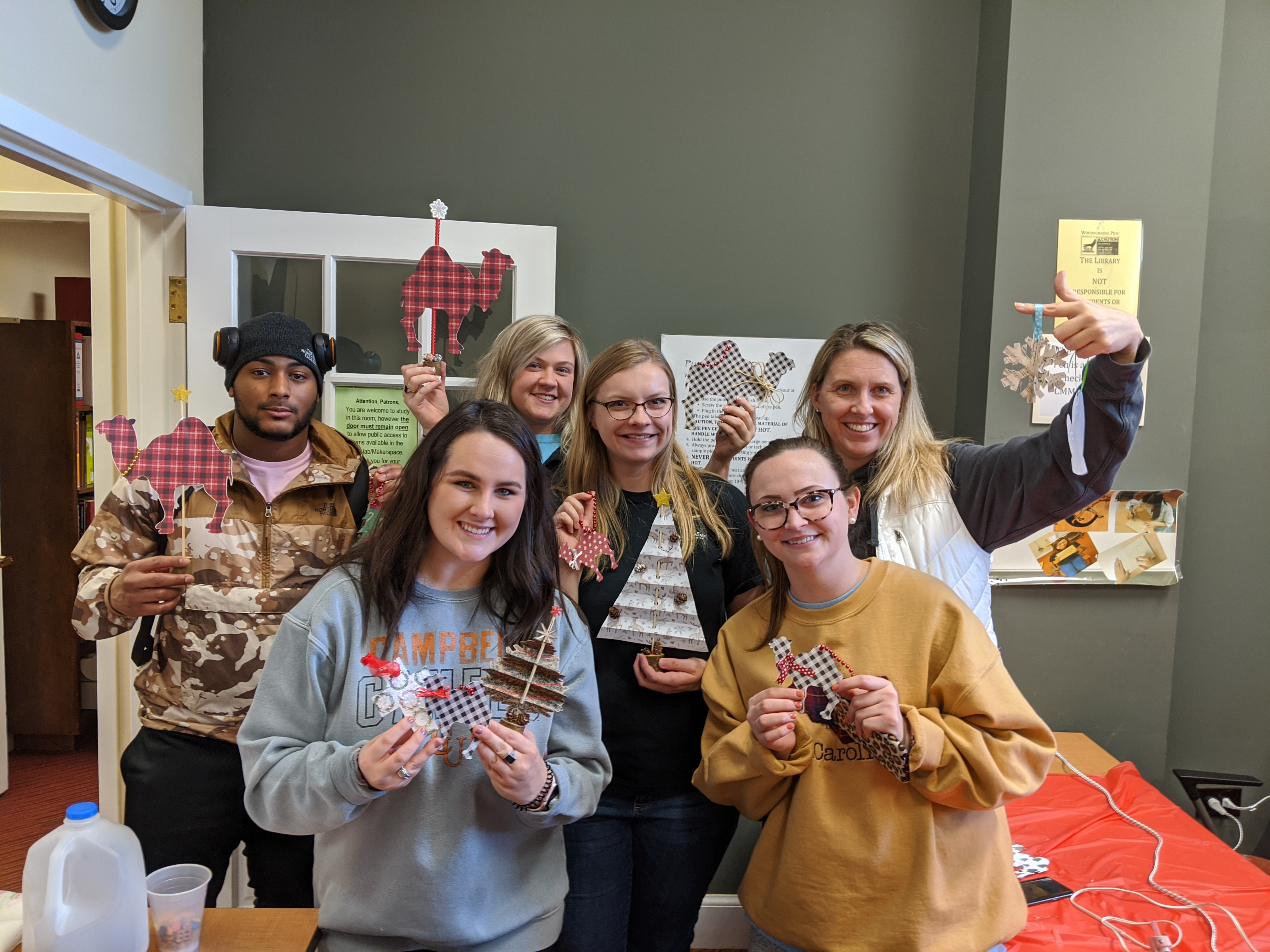 Group of students showing off their final craft projects