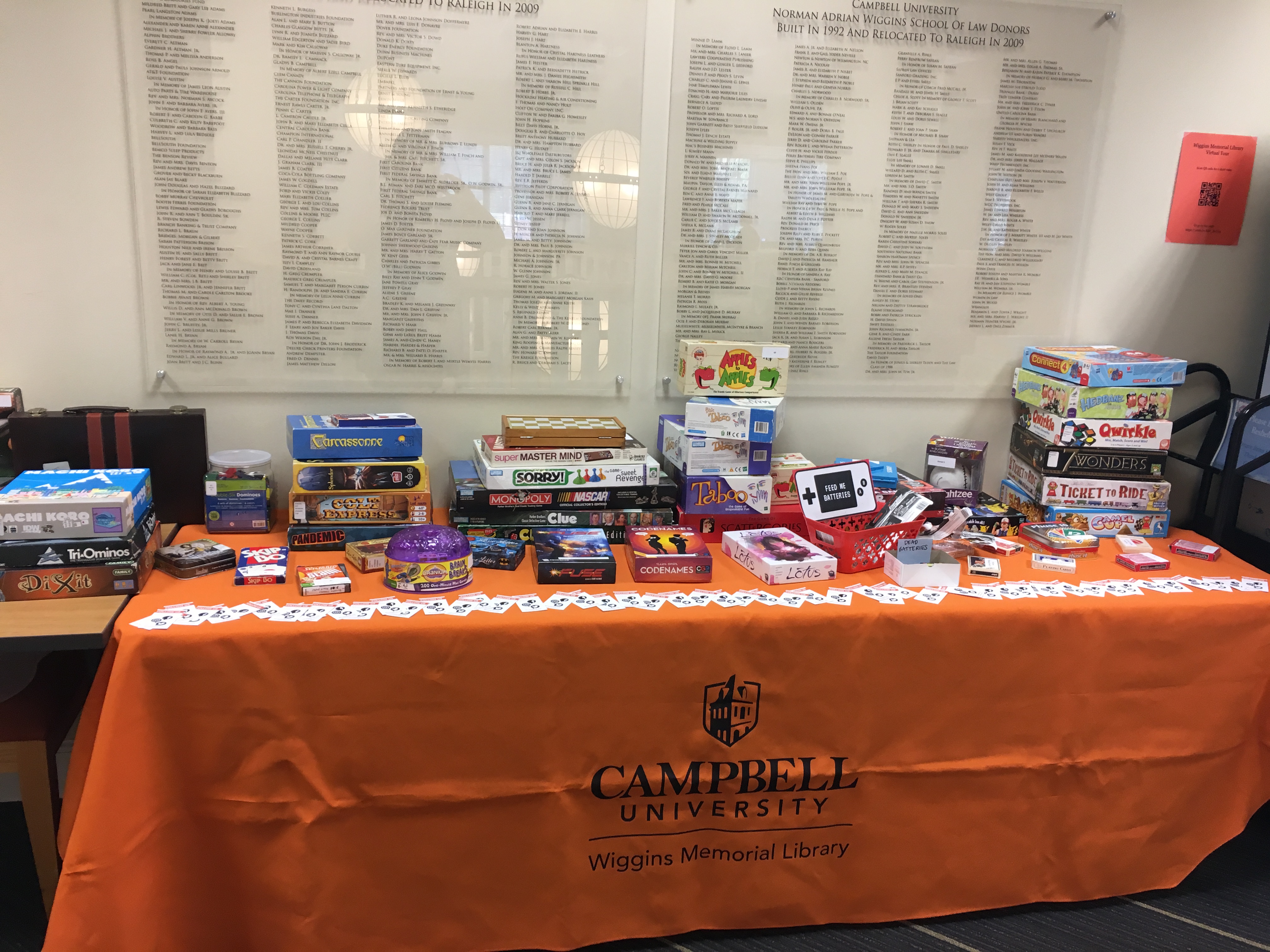 Table filled with all the different board games offered at game night