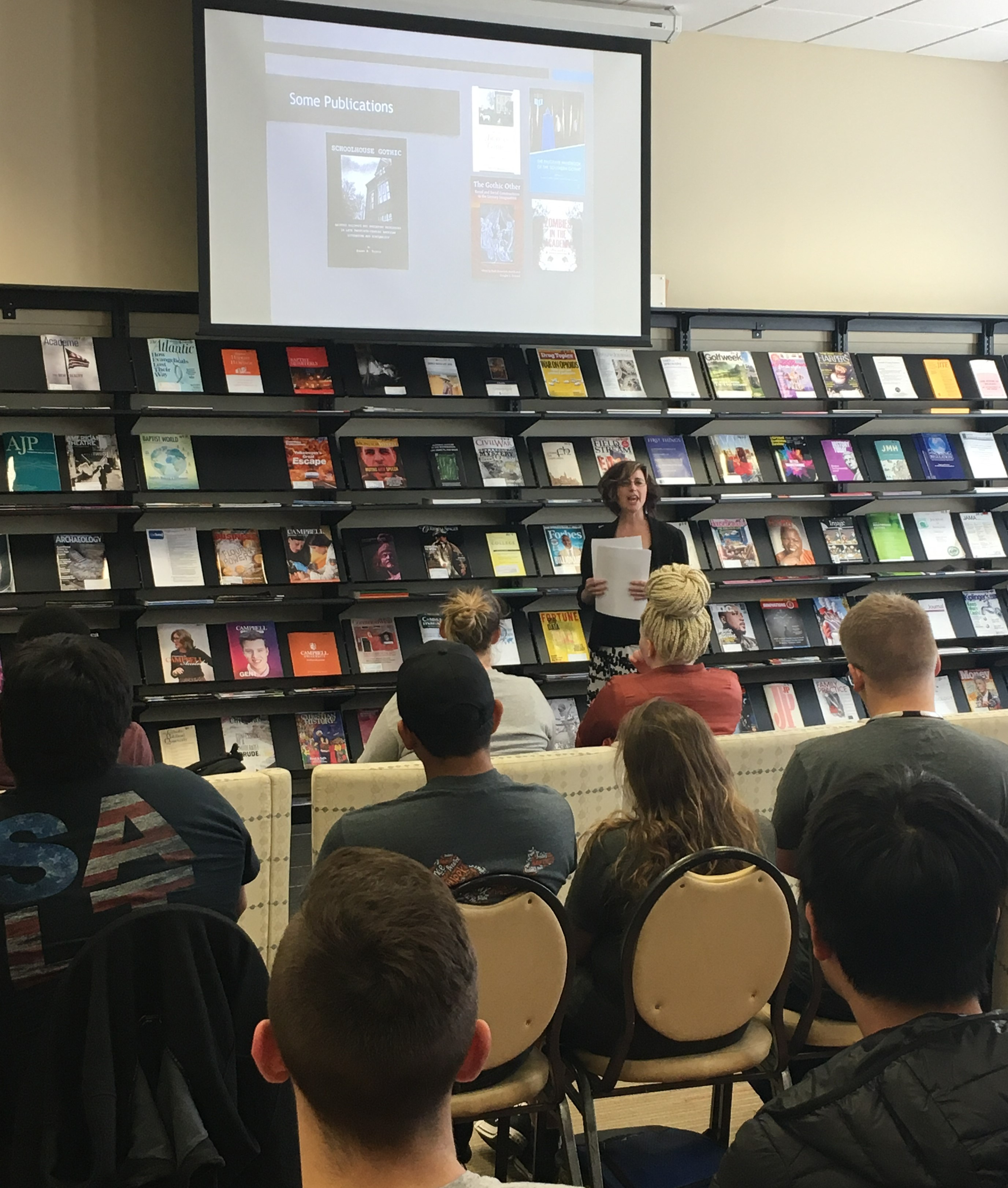 Faculty member presenting at Faculty Lightning talks with audience engaged