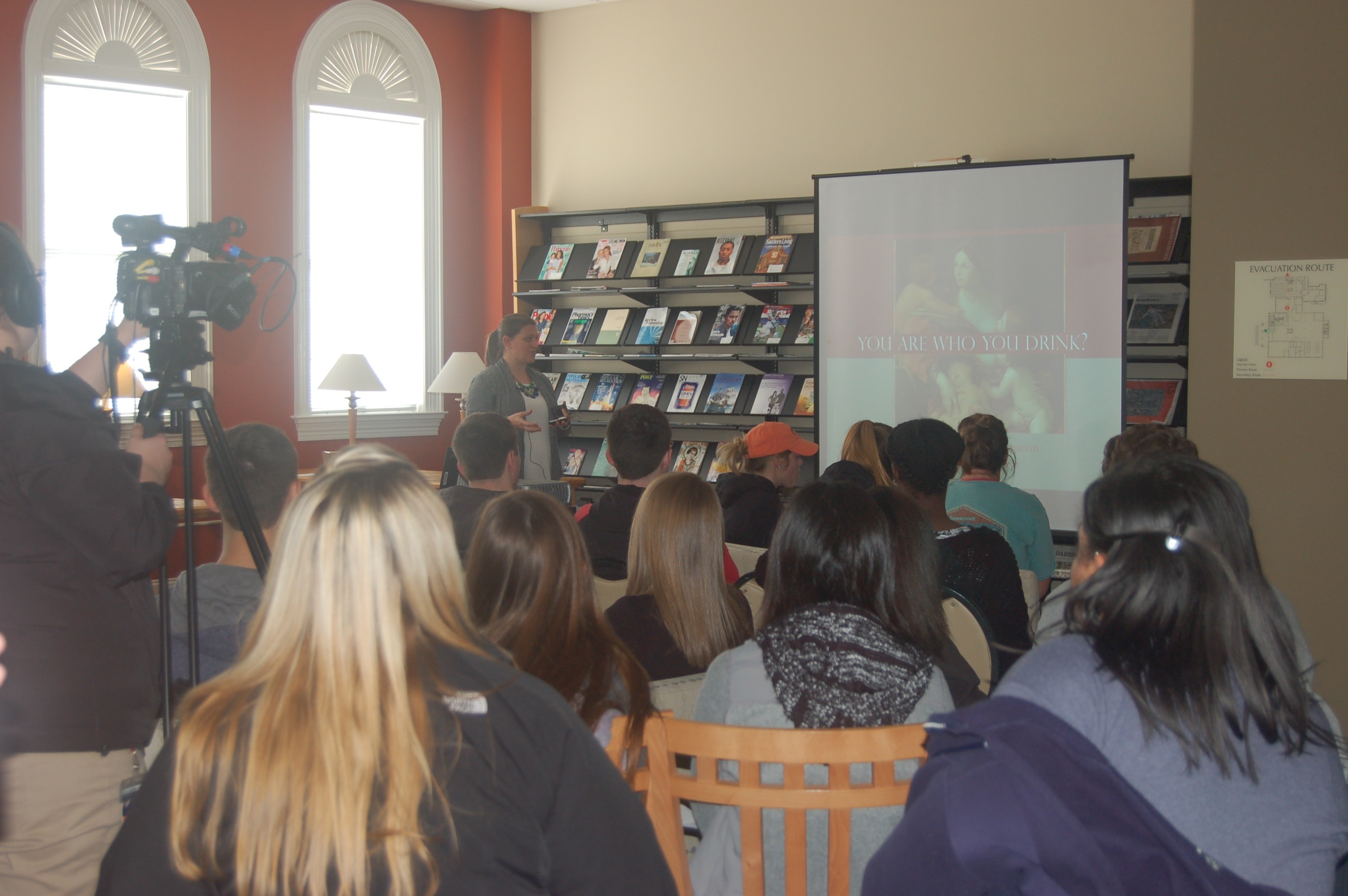 Faculty member presenting at Faculty Lightning talks with audience engaged